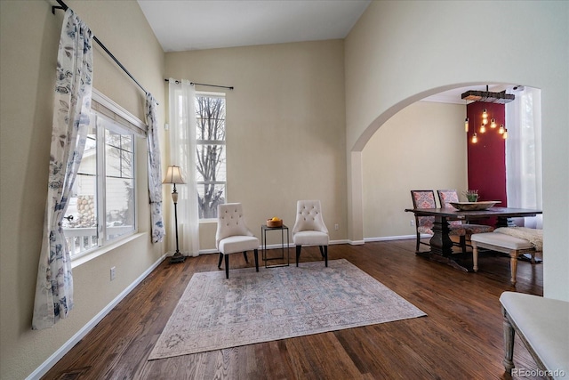 sitting room with an inviting chandelier and dark wood-type flooring