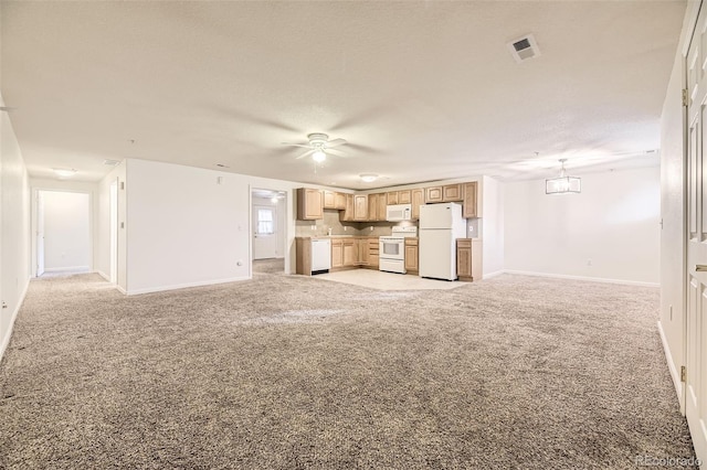 unfurnished living room with a textured ceiling, light colored carpet, and ceiling fan