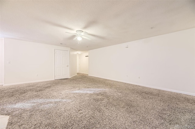 unfurnished room featuring carpet flooring, ceiling fan, and a textured ceiling