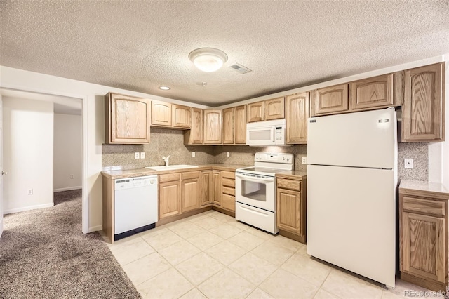 kitchen featuring decorative backsplash, light brown cabinetry, a textured ceiling, white appliances, and sink