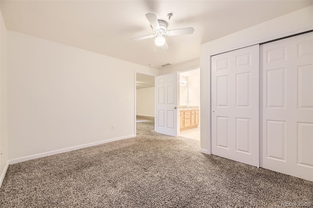 unfurnished bedroom with connected bathroom, ceiling fan, a closet, and carpet floors