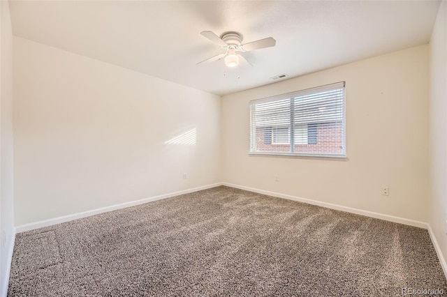 carpeted spare room with ceiling fan