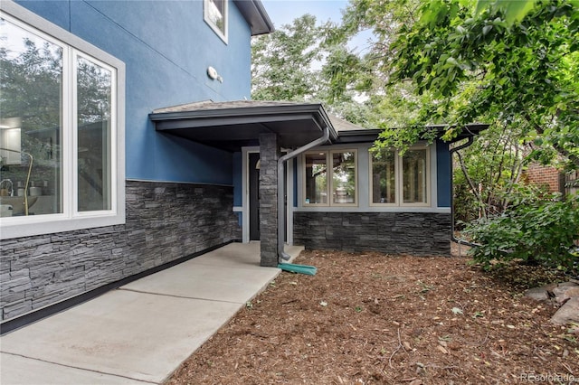 2143 S Downing St, Denver, CO 80210 - view of side of home featuring stone siding and stucco siding