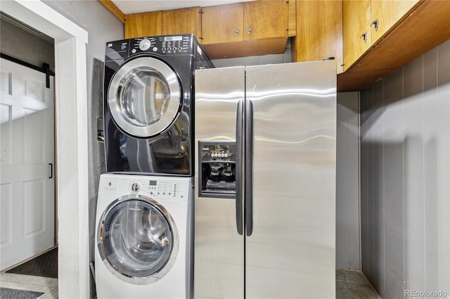 2143 S Downing St, Denver, CO 80210 - laundry room with stacked washing machine and dryer and tile patterned flooring