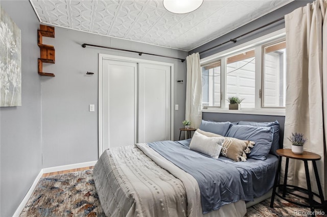 2143 S Downing St, Denver, CO 80210 - bedroom featuring an ornate ceiling, wood finished floors, and a closet