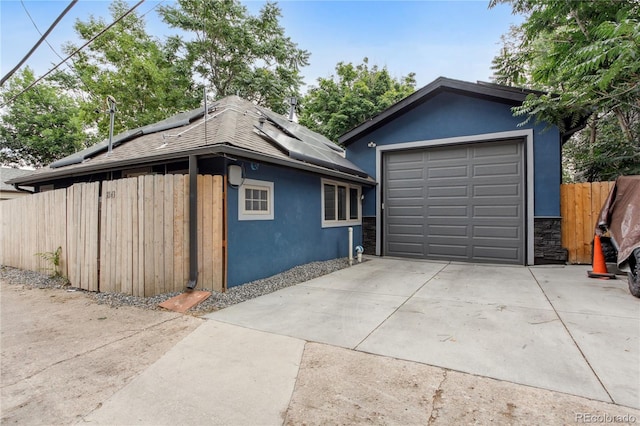 2143 S Downing St, Denver, CO 80210 - garage featuring driveway and solar panels