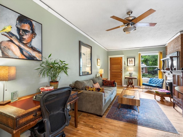 living room with crown molding, light hardwood / wood-style flooring, a textured ceiling, and ceiling fan