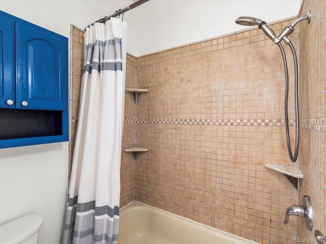 bathroom featuring shower / bath combination with curtain and toilet