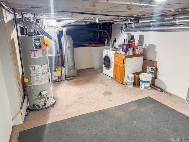 basement with heating unit, washer / dryer, carpet floors, and water heater