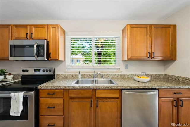2900 Krameria St, Denver, CO 80207 - kitchen with stainless steel appliances, brown cabinets, and light stone counters