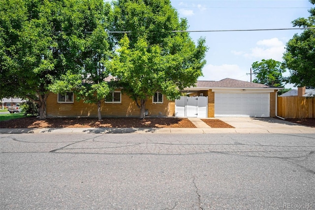 2900 Krameria St, Denver, CO 80207 - view of front of property featuring a garage, concrete driveway, and brick siding