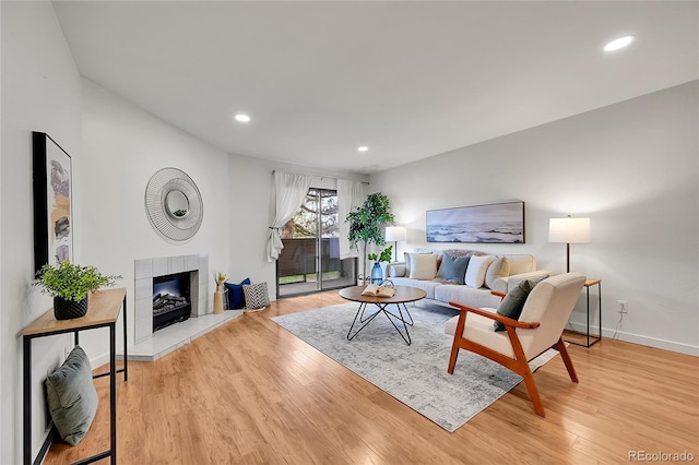 201 Wright St Unit 105, Lakewood, CO 80228 - living area featuring wood finished floors, recessed lighting, a tiled fireplace, and baseboards