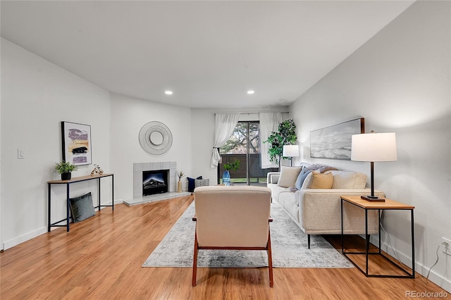 201 Wright St Unit 105, Lakewood, CO 80228 - living room with light wood-type flooring, recessed lighting, a tile fireplace, and baseboards