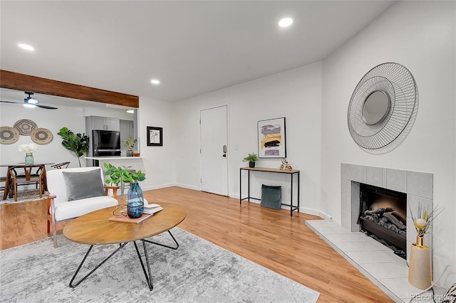 201 Wright St Unit 105, Lakewood, CO 80228 - living room featuring light wood-type flooring, a tiled fireplace, recessed lighting, ceiling fan, and baseboards