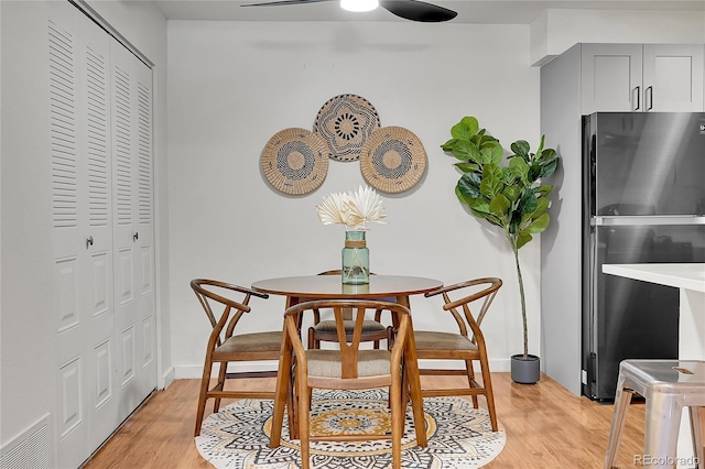 201 Wright St Unit 105, Lakewood, CO 80228 - dining space with a ceiling fan, light wood finished floors, and baseboards