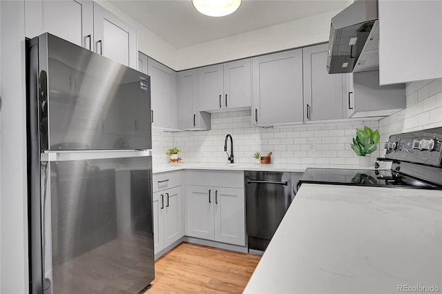 201 Wright St Unit 105, Lakewood, CO 80228 - kitchen with freestanding refrigerator, black / electric stove, a sink, dishwasher, and ventilation hood