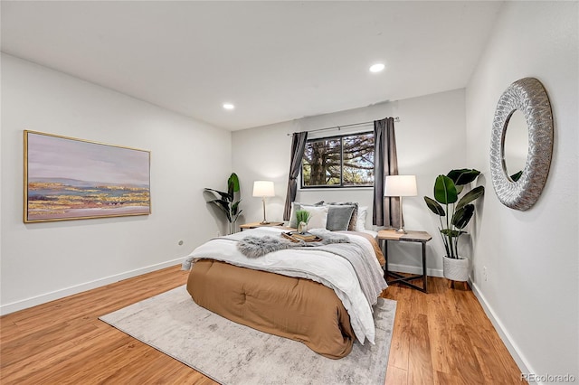 201 Wright St Unit 105, Lakewood, CO 80228 - bedroom with wood finished floors, baseboards, and recessed lighting