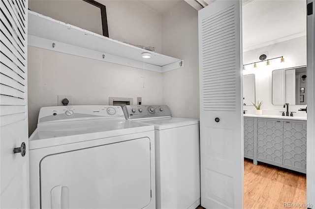 201 Wright St Unit 105, Lakewood, CO 80228 - laundry area featuring washer and dryer and light wood-style floors