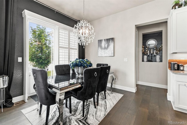 10080 E 160th Pl, Brighton, CO 80602 - dining area with a chandelier, dark wood-style floors, and baseboards