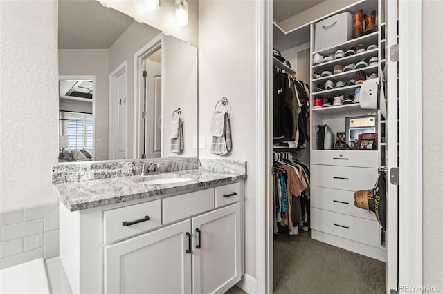 10080 E 160th Pl, Brighton, CO 80602 - bathroom featuring vanity and a walk in closet