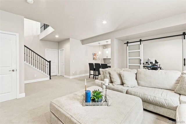 10080 E 160th Pl, Brighton, CO 80602 - living room with a barn door, light carpet, stairs, baseboards, and recessed lighting