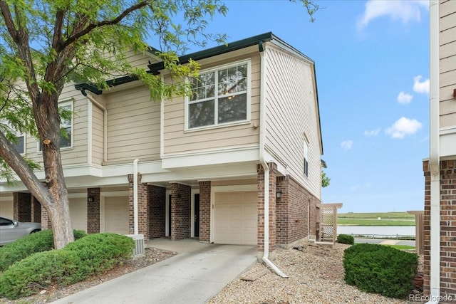1631 Egret Way, Superior, CO 80027 - view of front facade with brick siding, a garage, a water view, and concrete driveway