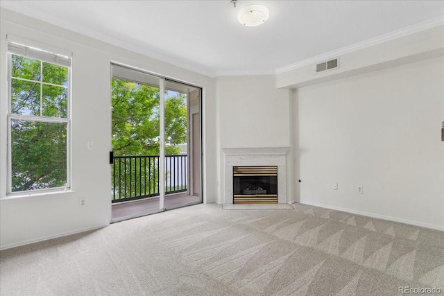 1631 Egret Way, Superior, CO 80027 - unfurnished living room featuring healthy amount of natural light, carpet, crown molding, a premium fireplace, and baseboards