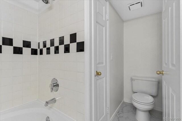 1631 Egret Way, Superior, CO 80027 - full bath featuring marble look tile flooring, toilet, baseboards, and shower / washtub combination
