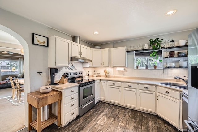 kitchen with a wealth of natural light, sink, stainless steel electric range, and white cabinets