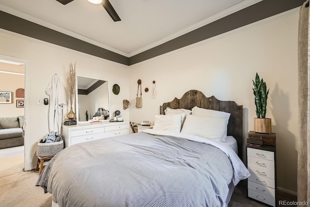 carpeted bedroom with ceiling fan and ornamental molding