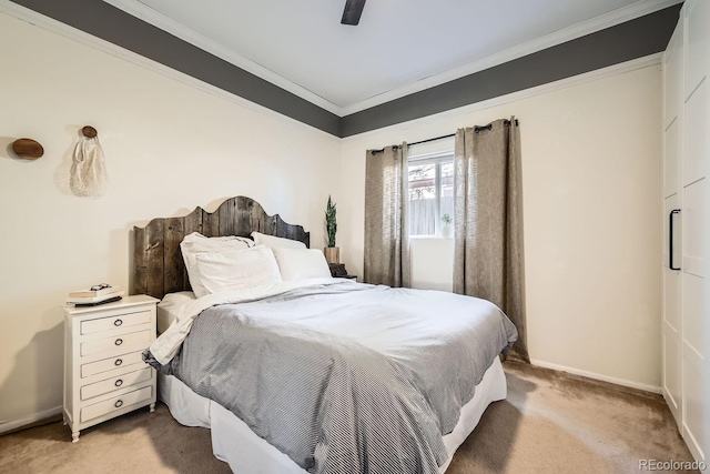 carpeted bedroom with crown molding and ceiling fan