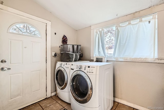 laundry area featuring a healthy amount of sunlight, separate washer and dryer, and tile patterned flooring