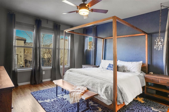 bedroom featuring hardwood / wood-style floors and ceiling fan