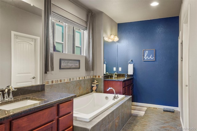 bathroom with vanity and a relaxing tiled tub