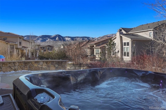 view of pool featuring a hot tub and a mountain view