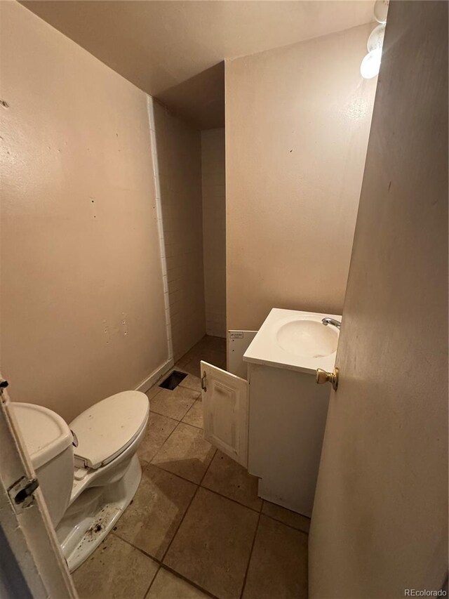 bathroom featuring vanity, toilet, and tile patterned floors