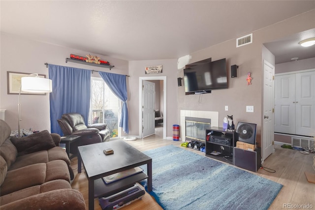 8707 E Florida Ave Unit 410, Denver, CO 80247 - living room featuring baseboards, visible vents, and wood finished floors