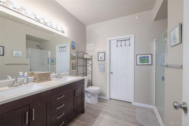 8707 E Florida Ave Unit 410, Denver, CO 80247 - bathroom featuring a sink, a shower stall, toilet, and double vanity