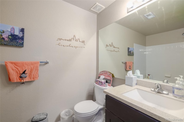 8707 E Florida Ave Unit 410, Denver, CO 80247 - bathroom featuring visible vents, toilet, and vanity