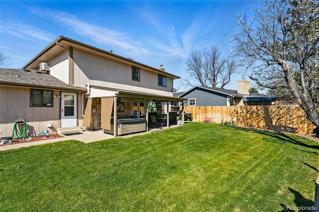 7314 W Walker Pl, Littleton, CO 80123 - rear view of property with a patio, a yard, fence, and a hot tub