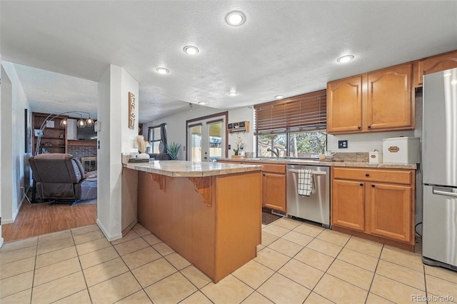 7314 W Walker Pl, Littleton, CO 80123 - kitchen featuring stainless steel appliances, a peninsula, recessed lighting, light countertops, and light tile patterned floors