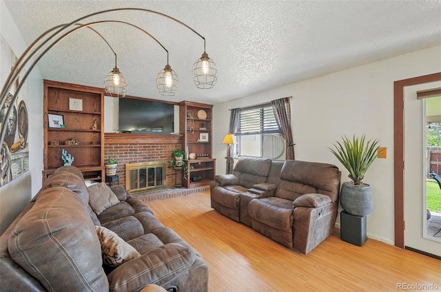 7314 W Walker Pl, Littleton, CO 80123 - living area with a fireplace, wood finished floors, and a textured ceiling