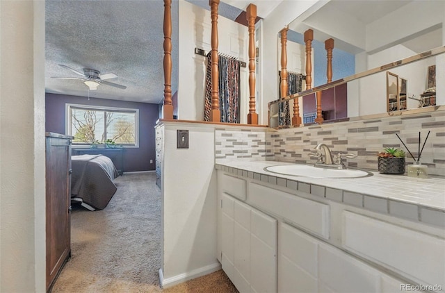 7314 W Walker Pl, Littleton, CO 80123 - ensuite bathroom with decorative backsplash, baseboards, a ceiling fan, and vanity