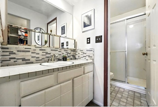 7314 W Walker Pl, Littleton, CO 80123 - full bath featuring toilet, decorative backsplash, a stall shower, and vanity