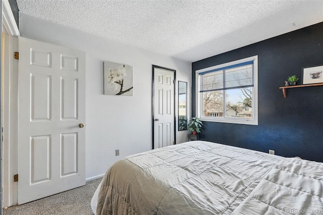 7314 W Walker Pl, Littleton, CO 80123 - bedroom featuring a textured ceiling, a closet, carpet flooring, and baseboards