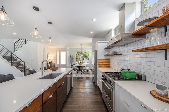 4180 Ames St, Denver, CO 80212 - kitchen featuring open shelves, appliances with stainless steel finishes, wall chimney exhaust hood, light countertops, and recessed lighting
