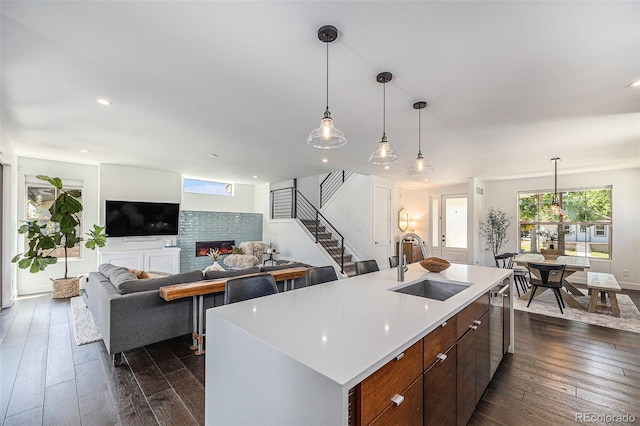 4180 Ames St, Denver, CO 80212 - kitchen featuring a glass covered fireplace, light countertops, dark wood-style flooring, pendant lighting, and recessed lighting
