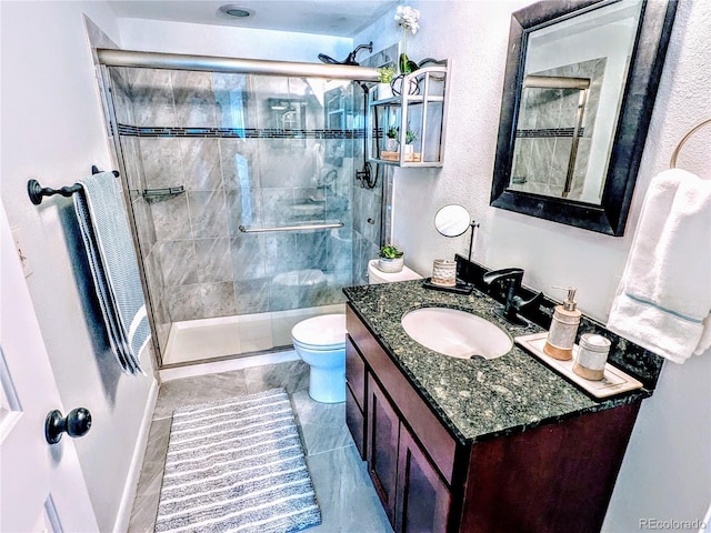 bathroom with vanity, toilet, and an enclosed shower