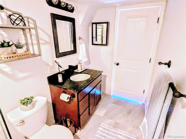 bathroom featuring toilet and vanity