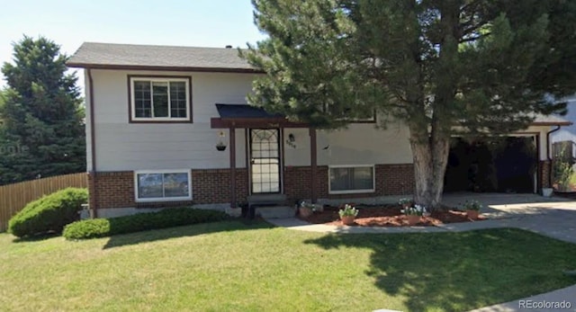 tri-level home with a garage and a front yard